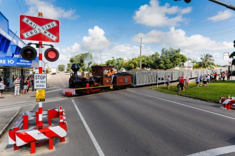 Cheered on by local residents and visitors, the preserved Homebush locomotive, celebrates her 100th birthday, crossing Herbert Street, Ingham with the first load of sugar cane for the Victoria Mill on the 23 June 2014 marking the commencement of the 2014 crushing season.  Image: Courtesy Wilmar Sugar