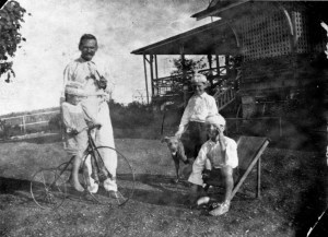 Albert Cook and his children Thomas, John and Althea, Christmas 1920.  The tricycle seen in the photo is still at the homestead.