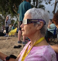Leonie Pulman watching the solar eclipse at Clifton Beach