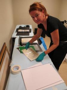 Dr Jo Wills removing water affected items from sleeves and drying on blotting paper.