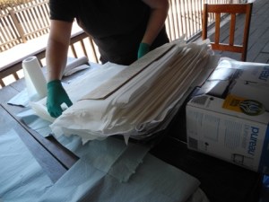 Interleaving a ledger with paper towels to help the drying process. (Photo: Helen Pithe).