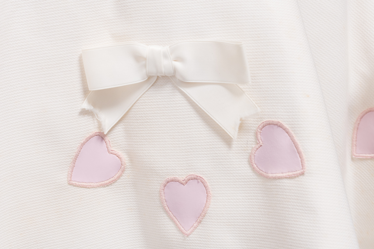 White cotton pique tennis dress consisting of a flared skirt attached to a fitted bodice shaped by double-ended darts at front and standard darts at back. Was worn at Wimbledon in the 1960s by Queensland tennis player and member of the 1962 Australian Women's Tennis Team, Madonna Schacht.